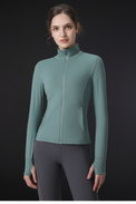Woman wearing a teal long-sleeve athletic jacket on a white background
